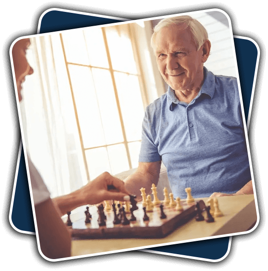 A man playing chess with an older gentleman.